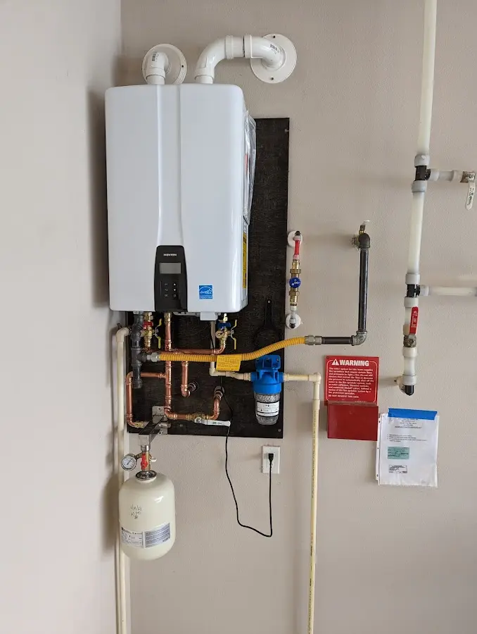 Professional plumber installing copper piping in a Post Falls home